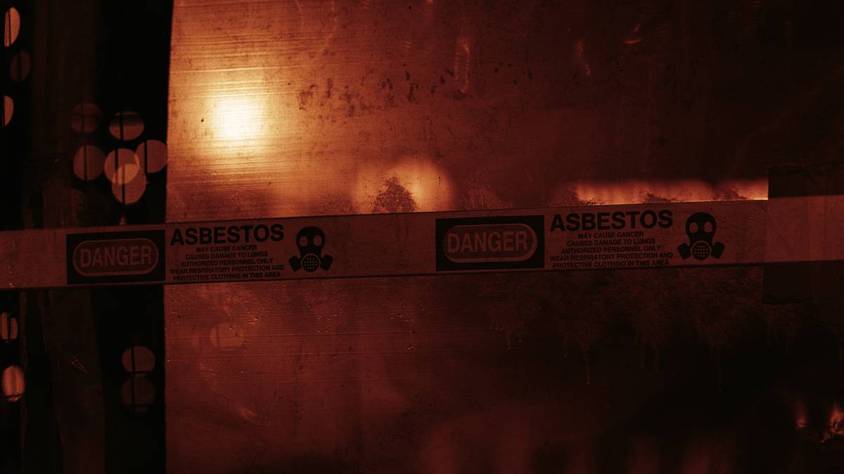 Contractor reviewing remediation cost estimates for asbestos removal in residential basement