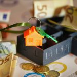 door keys banknotes finance chars real on table estate market